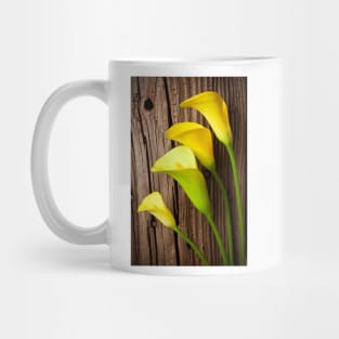 Calla lilies against wooden wall Mug